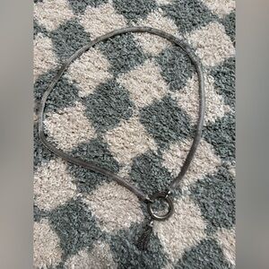 Silver tone chain mail statement belt with tassel and circular latch